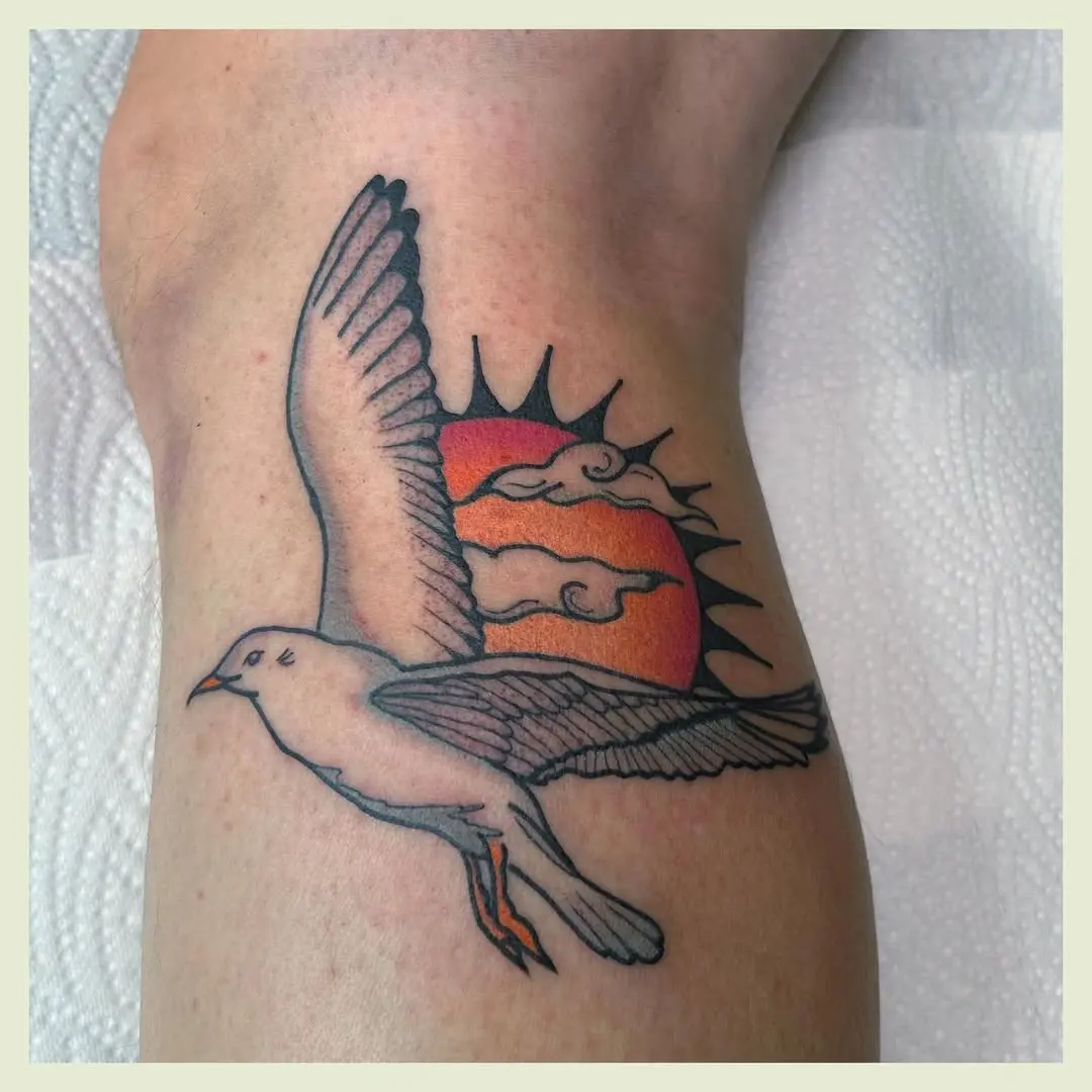 Elegant seagull soaring against a vibrant sunset