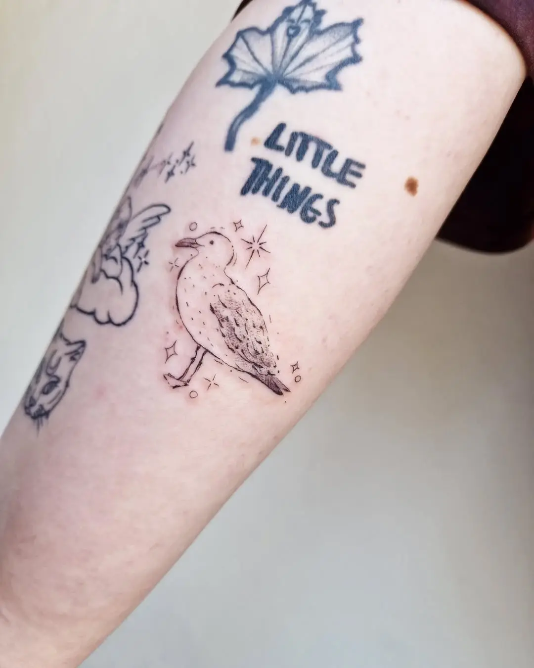 Charming minimal seagull tattoo on an arm