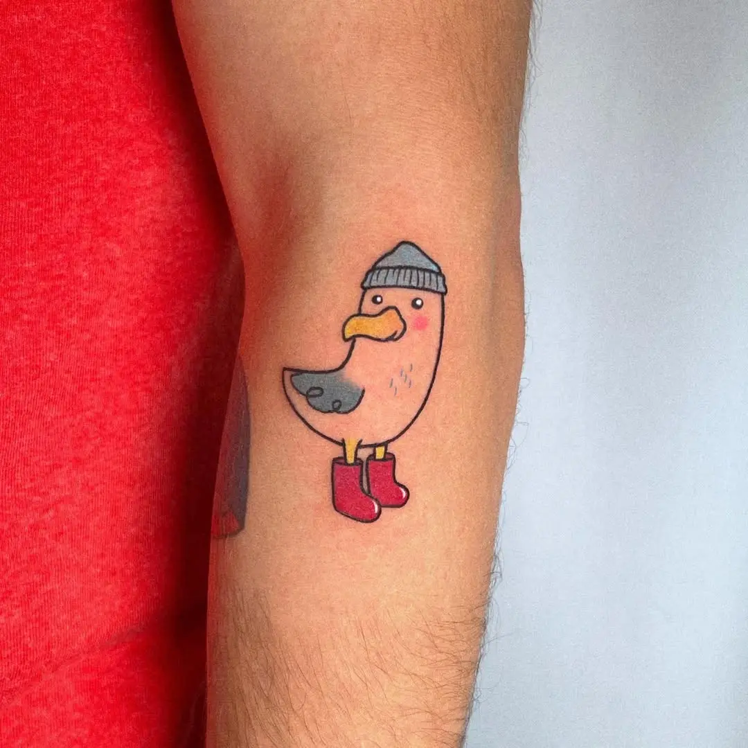 Playful seagull tattoo in vibrant colors
