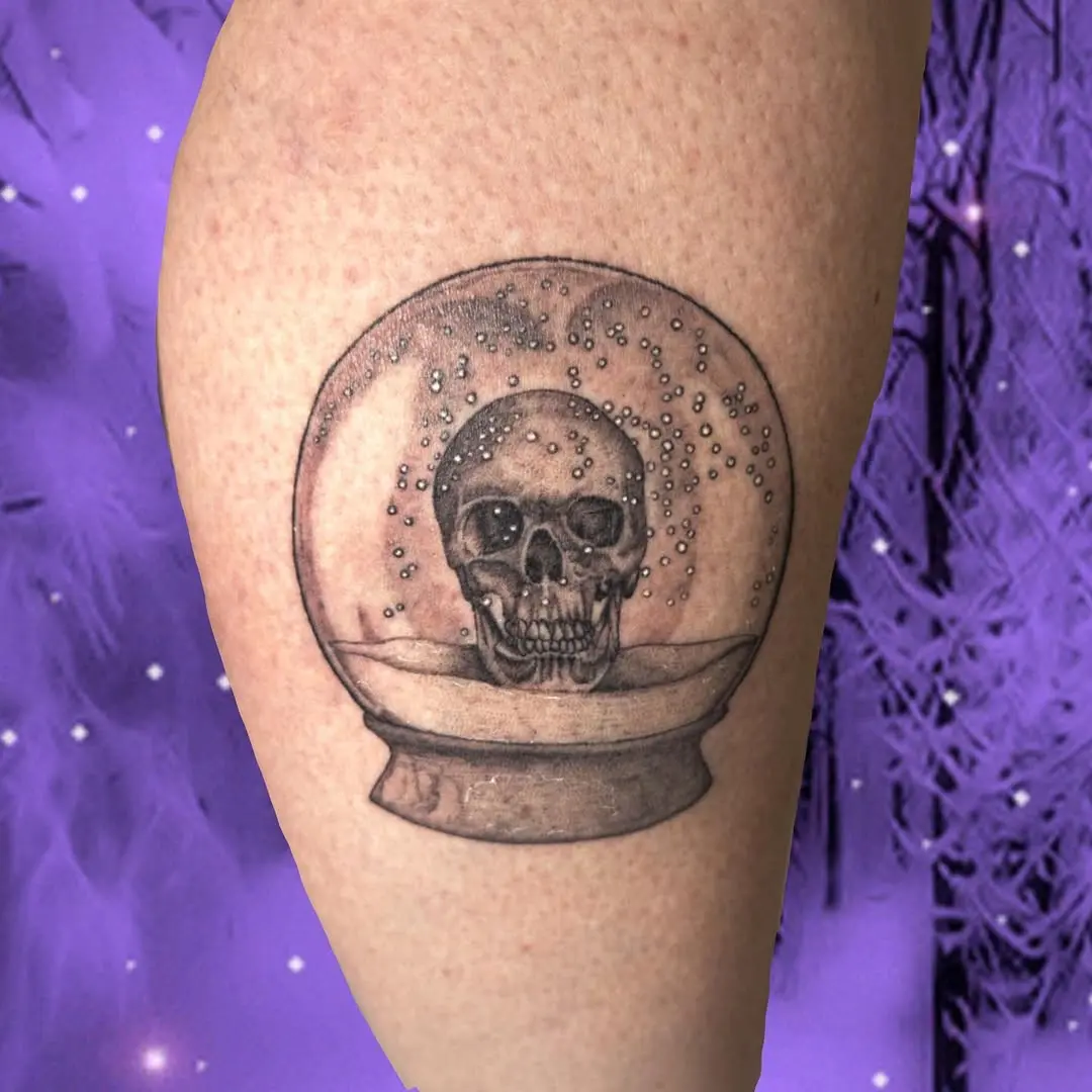 Intricate skull within a mesmerizing globe tattoo
