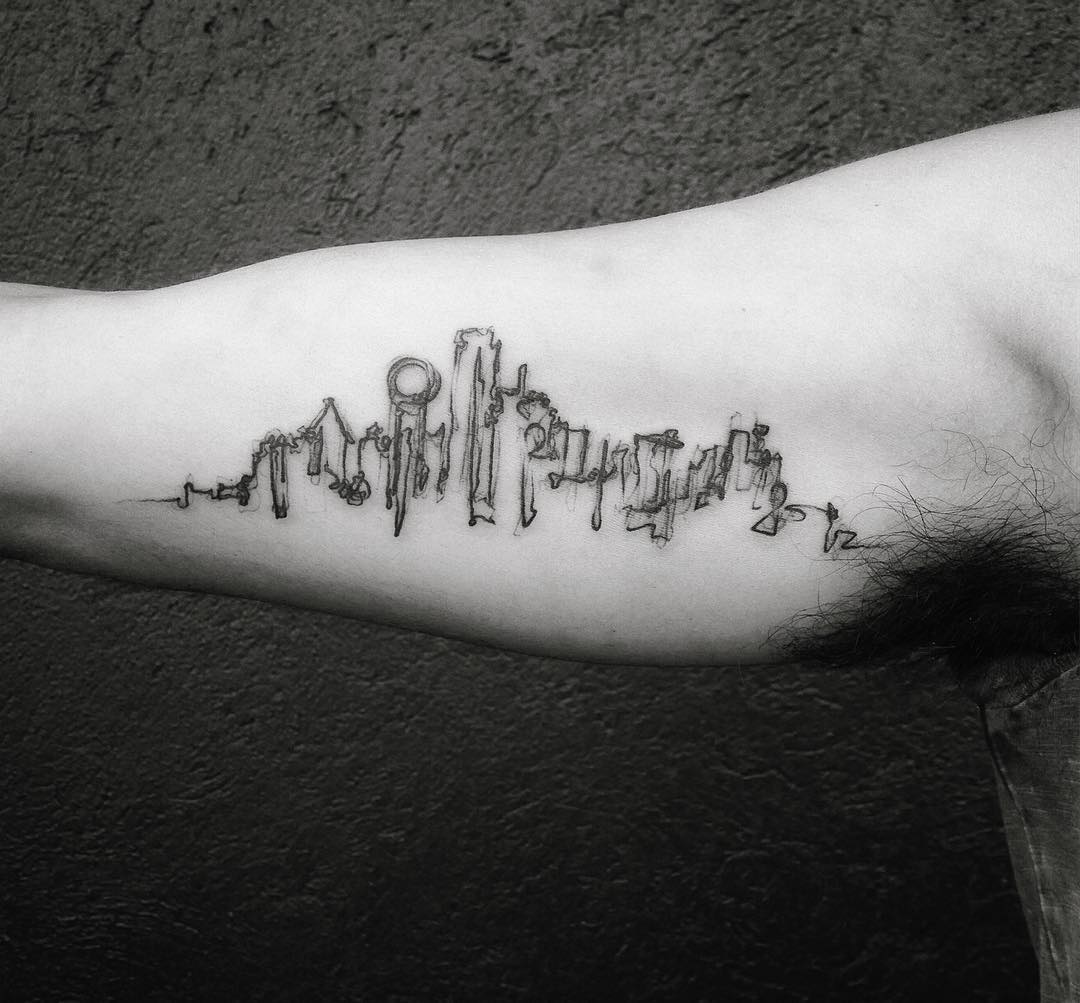 Minimalist skyline tattoo with urban flair