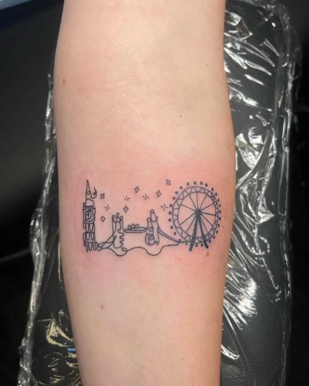 Minimalist skyline tattoo with iconic landmarks