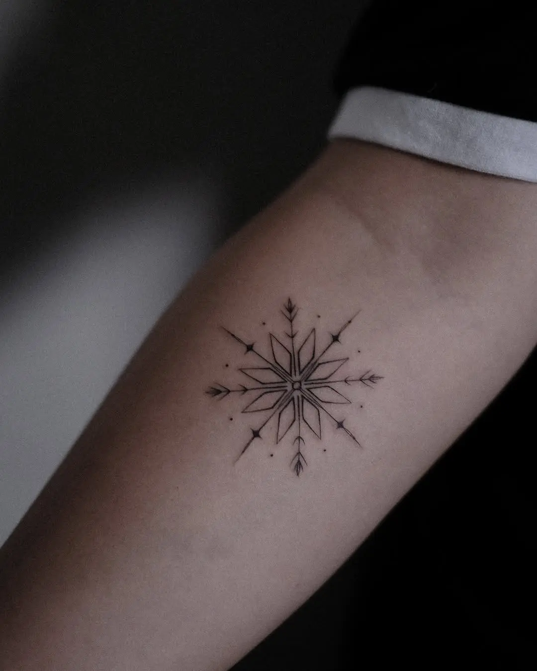 Elegantly crafted black snowflake tattoo design