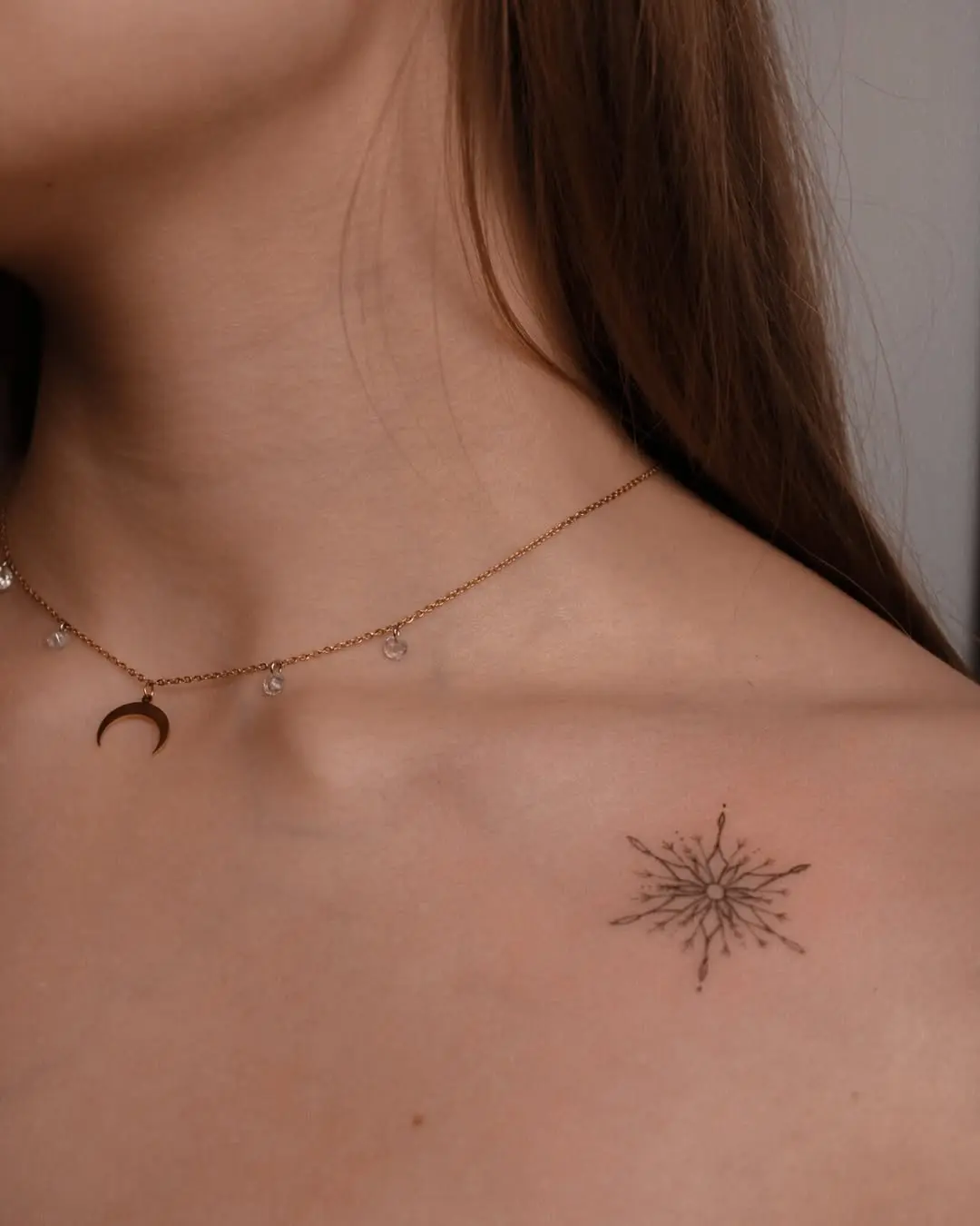 Delicate snowflake tattoo with jewelry charm