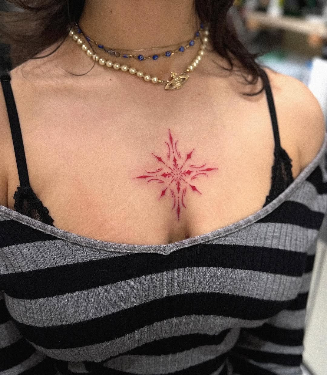 Unique Red Snowflake Tattoo on Chest