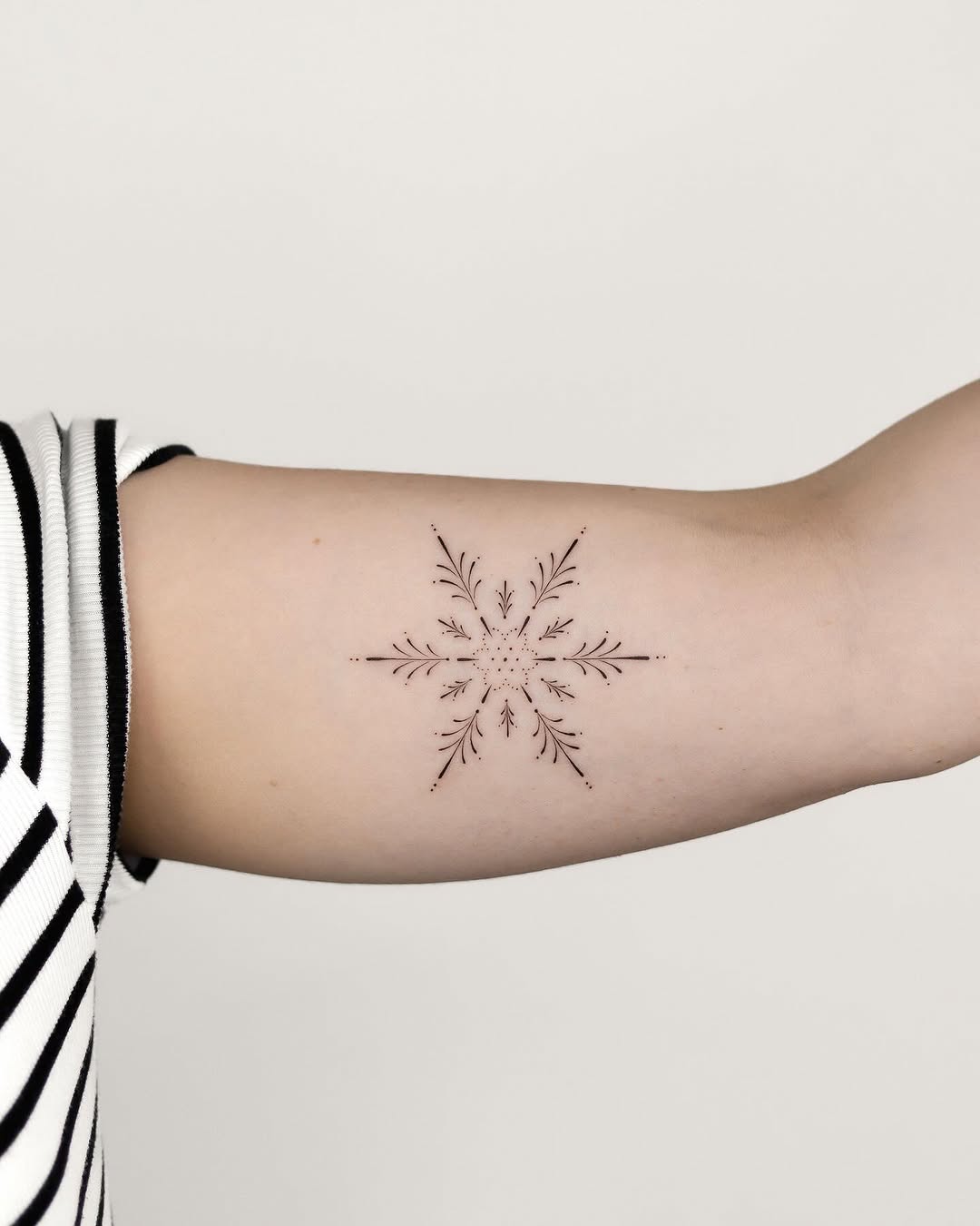 Elegant snowflake tattoo with delicate details