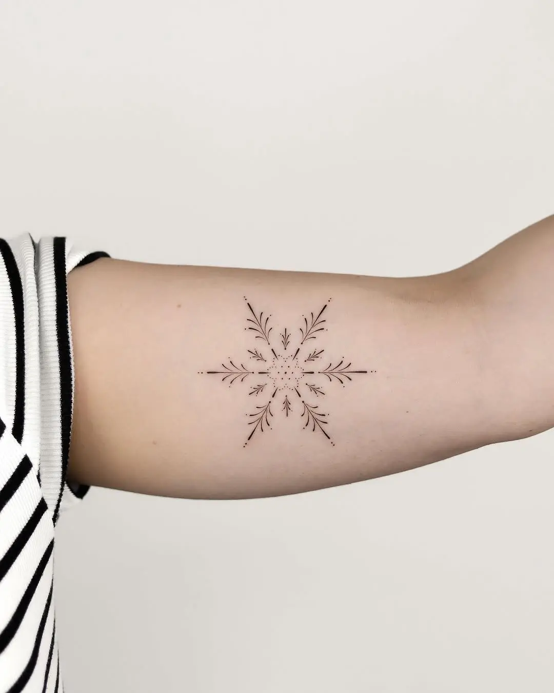 Elegant snowflake tattoo with delicate details