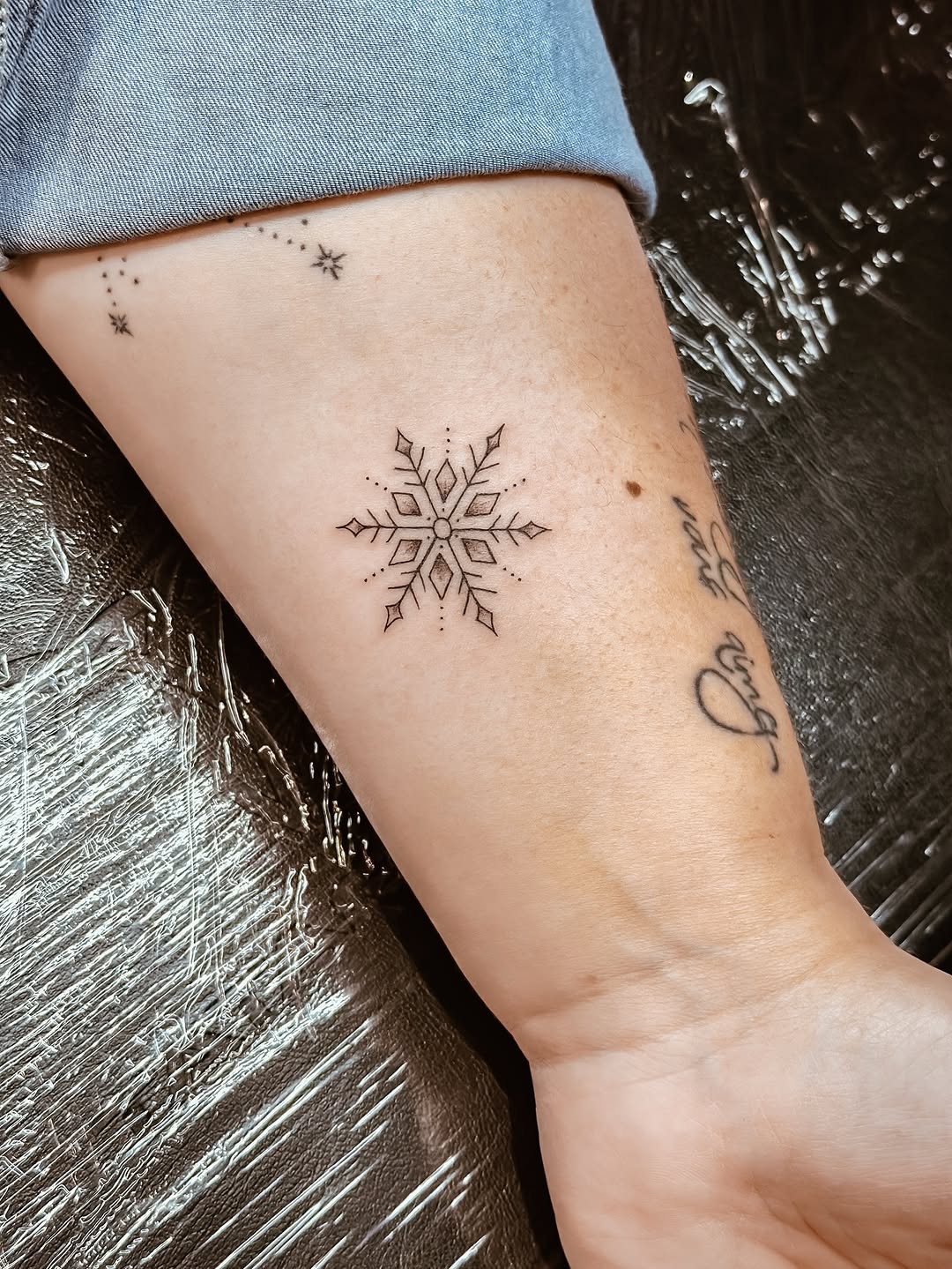 Exquisite minimalist snowflake tattoo design
