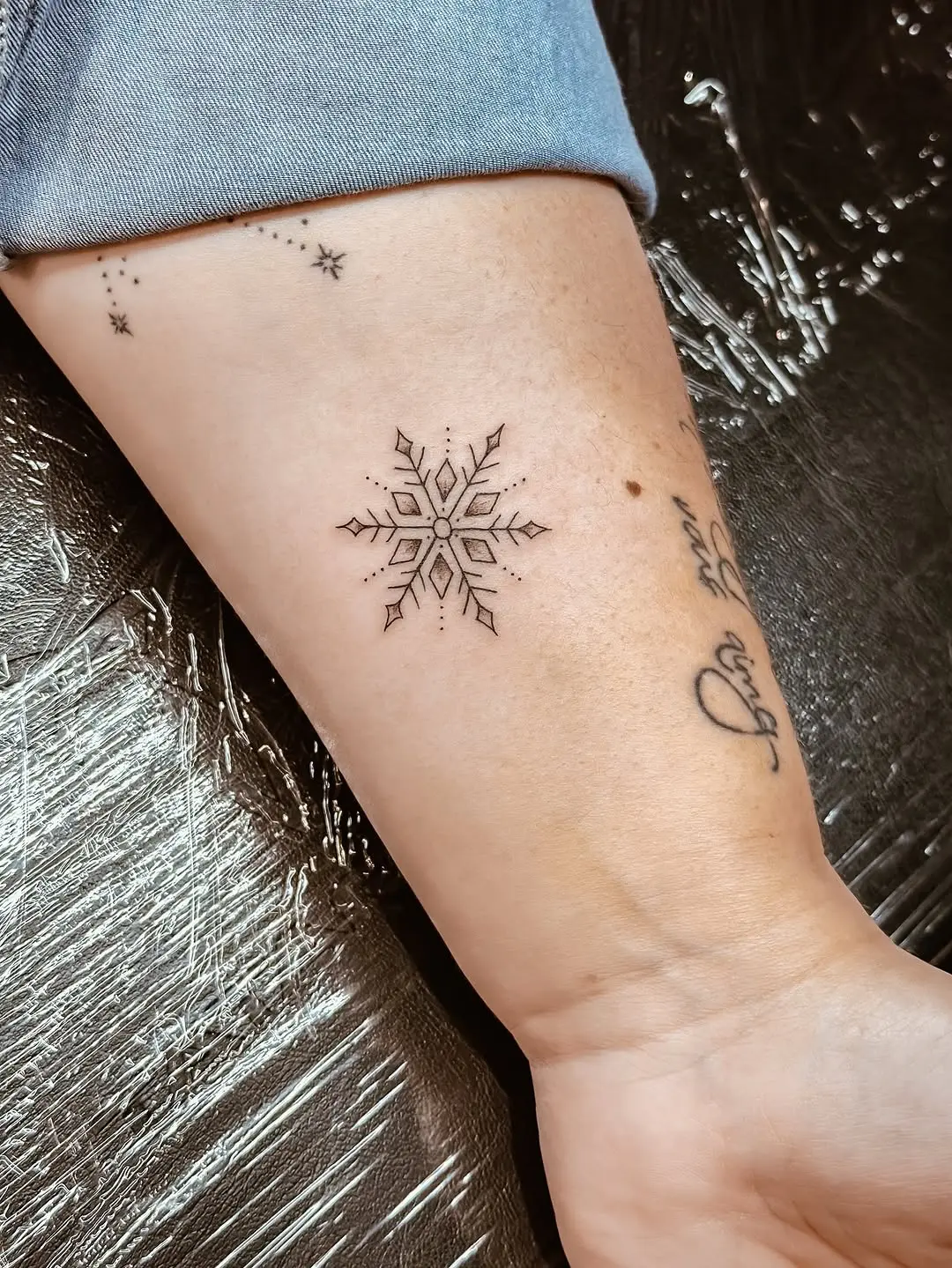 Exquisite minimalist snowflake tattoo design