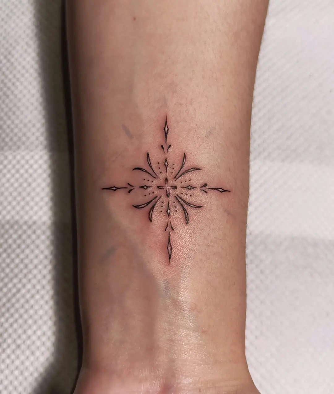 Beautifully crafted minimalistic snowflake tattoo
