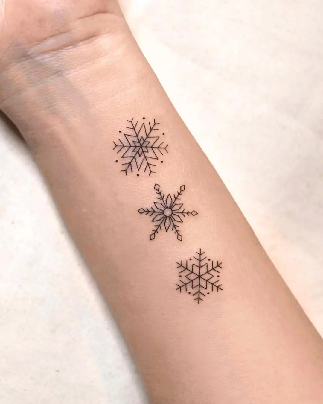 Charming minimalist snowflake tattoo designs