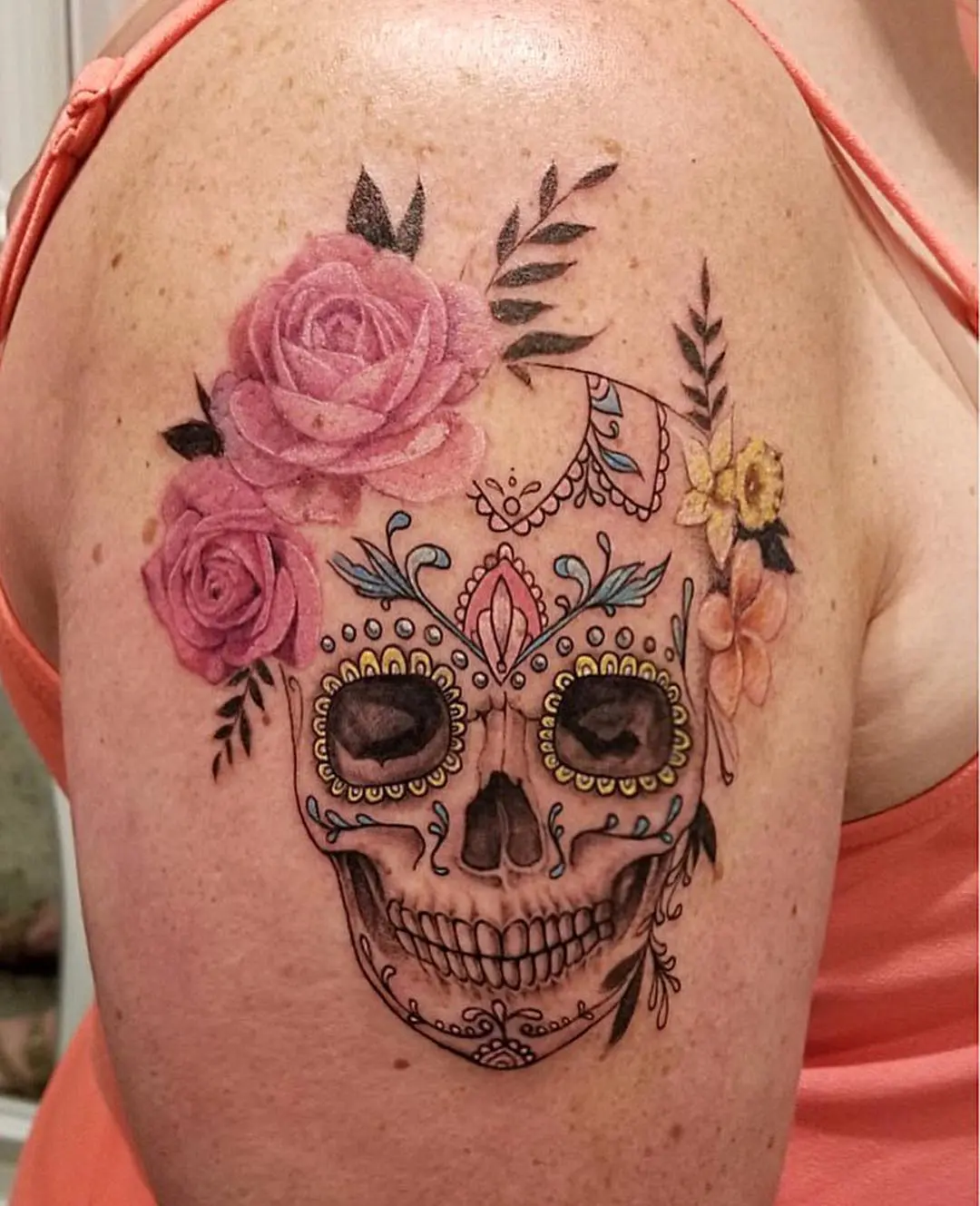 Vibrant sugar skull tattoo adorned with flowers