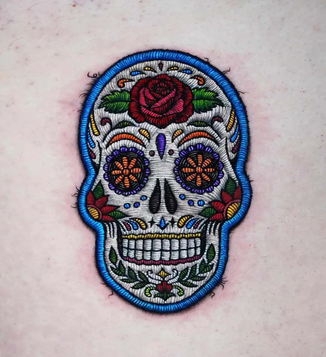 Vibrant sugar skull tattoo with floral motifs