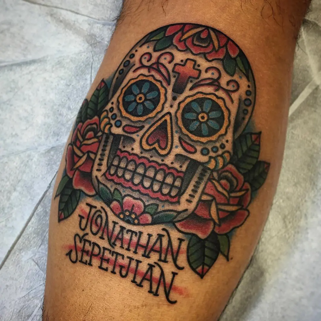 Vibrant sugar skull tattoo with floral details