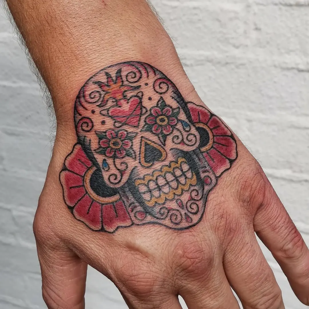 Vibrant sugar skull tattoo on hand