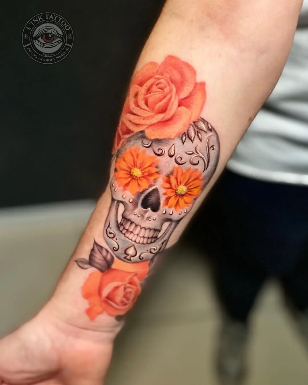 Vibrant sugar skull tattoo adorned with roses