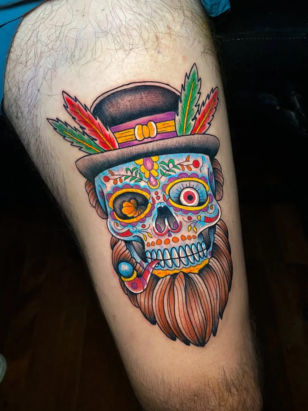 Vibrant Sugar Skull Tattoo with Feathers