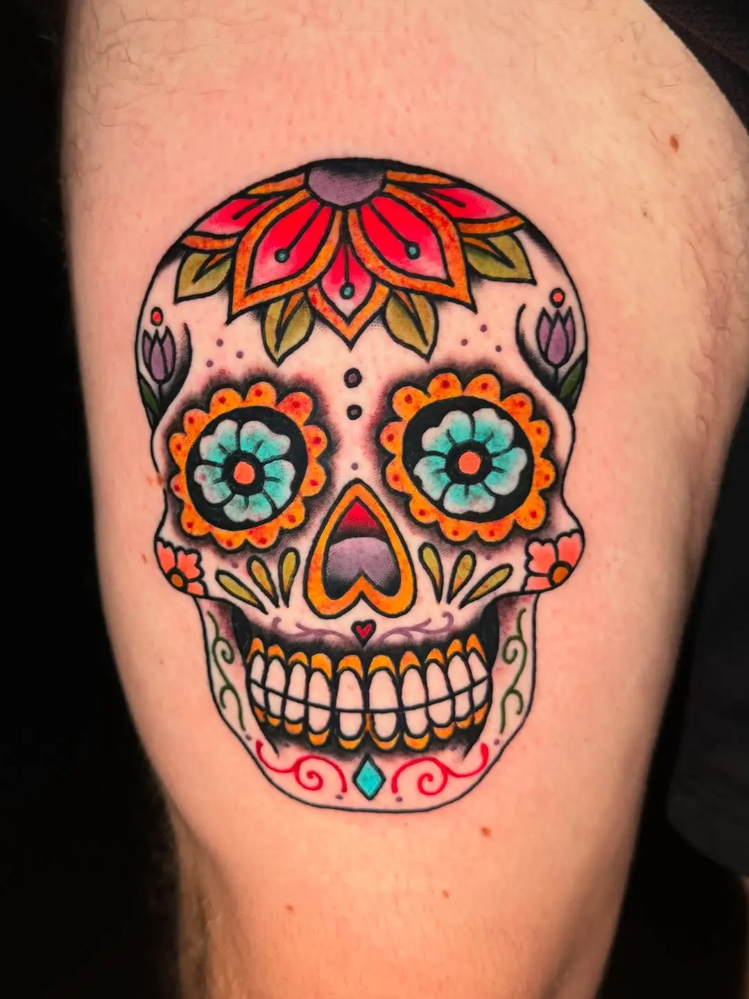 Vibrant sugar skull tattoo with floral elements