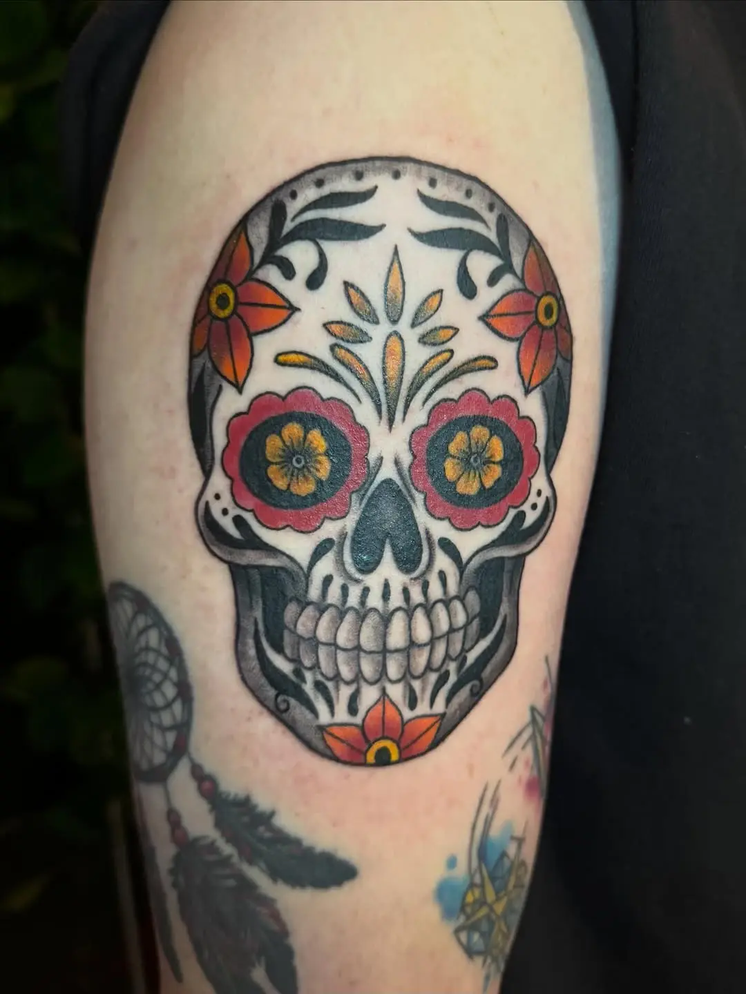 Vibrant sugar skull tattoo adorned with flowers