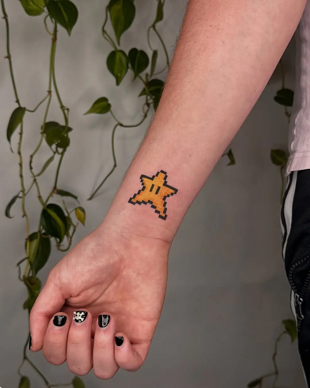 Playful pixel star tattoo capturing retro charm