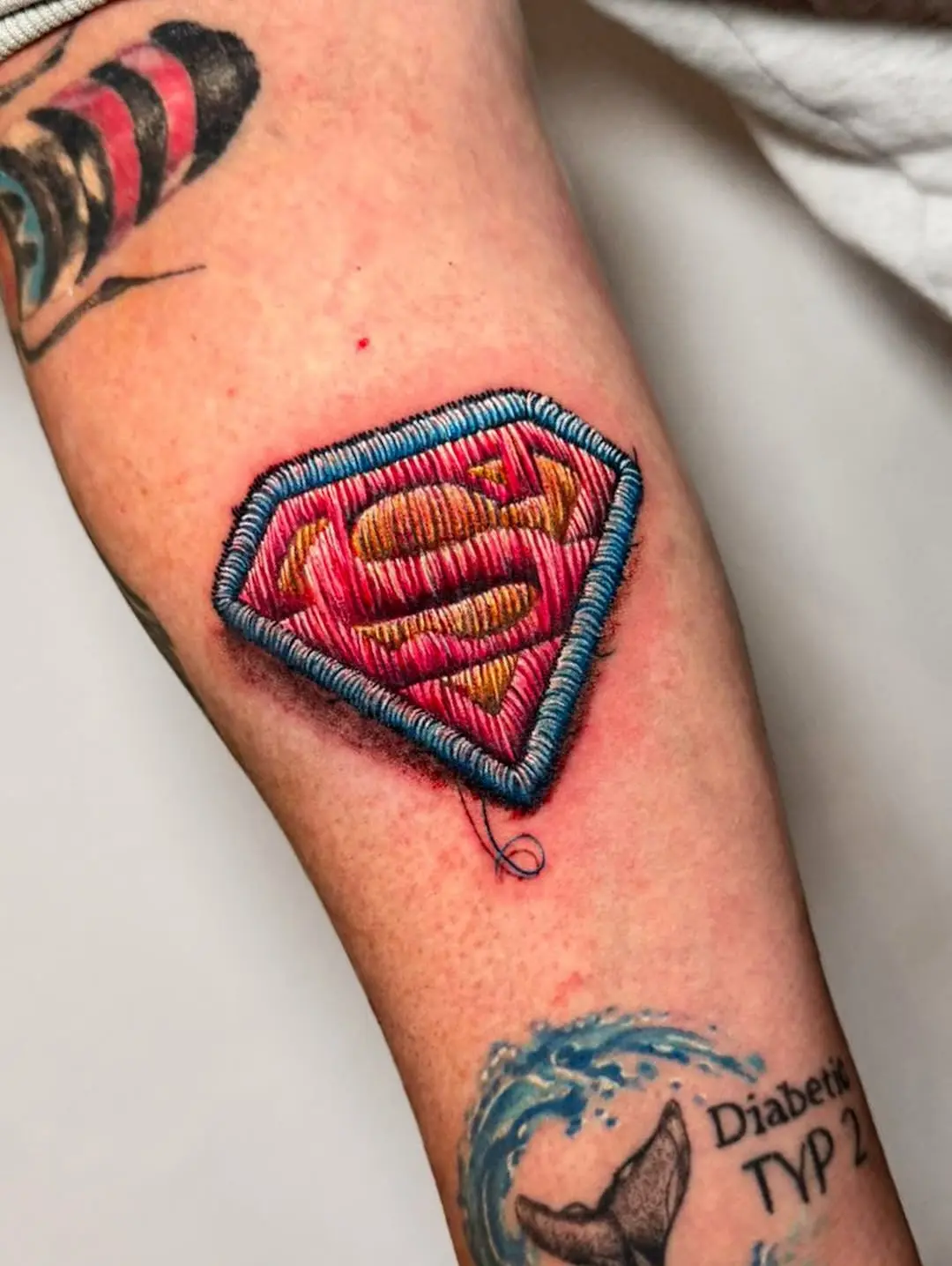 Vibrant embroidery-style Superman tattoo design