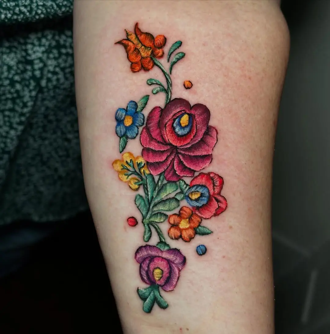Elegant floral embroidery-style tattoo design