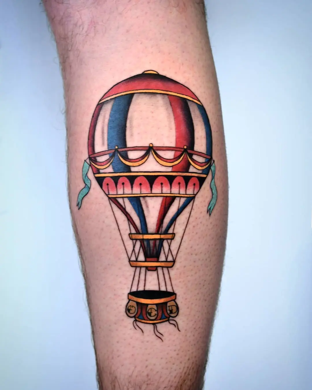 Colorful hot air balloon tattoo on leg