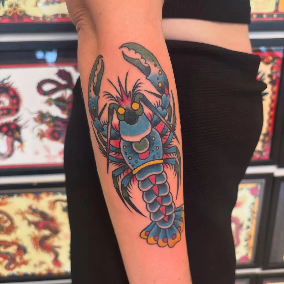 Vivid lobster tattoo on forearm showcasing color