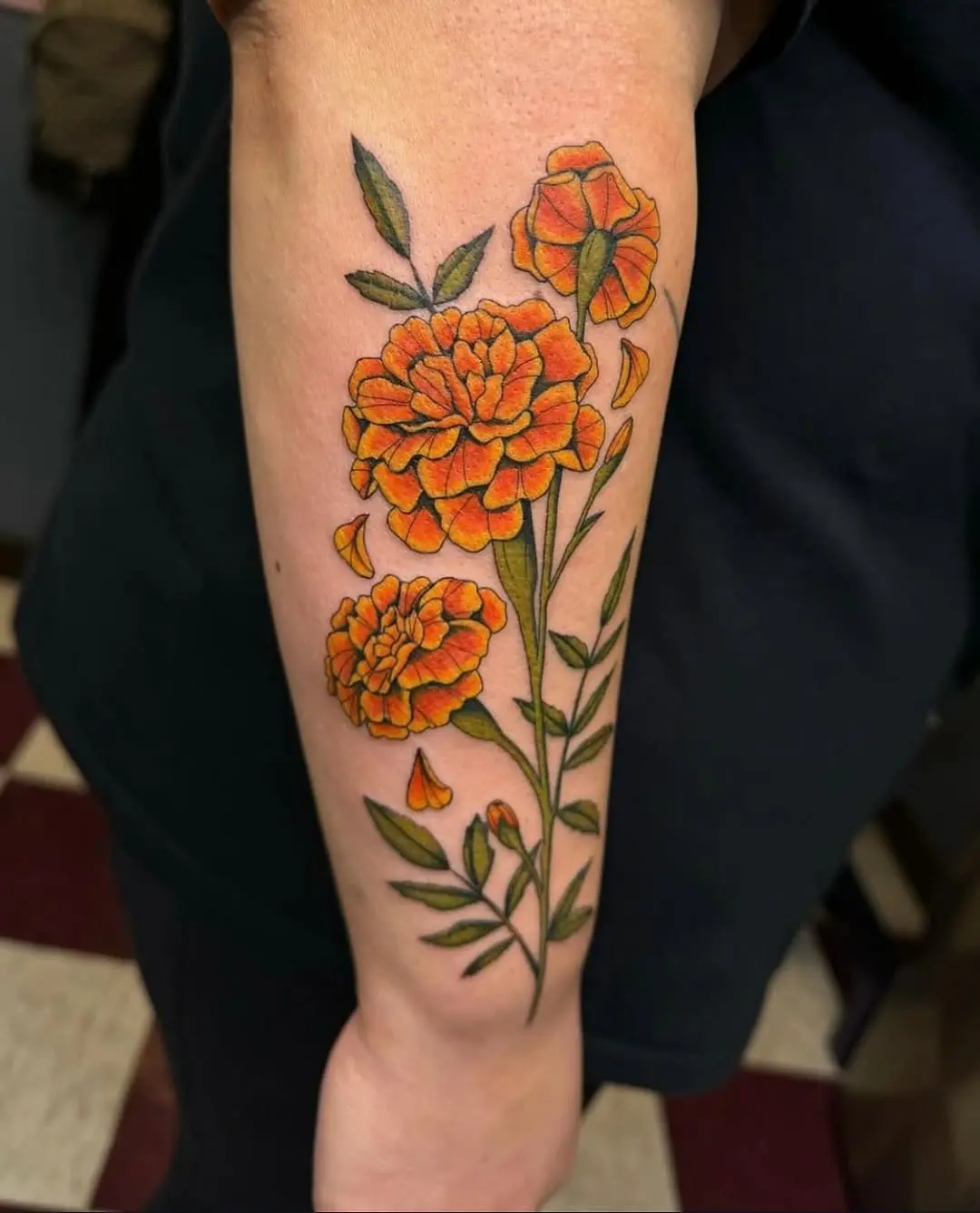 Vivid marigold tattoo showcasing floral beauty