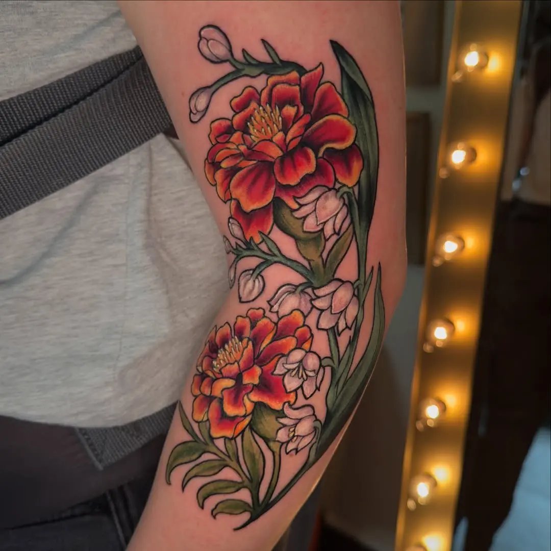 Bright marigold tattoo with floral accents
