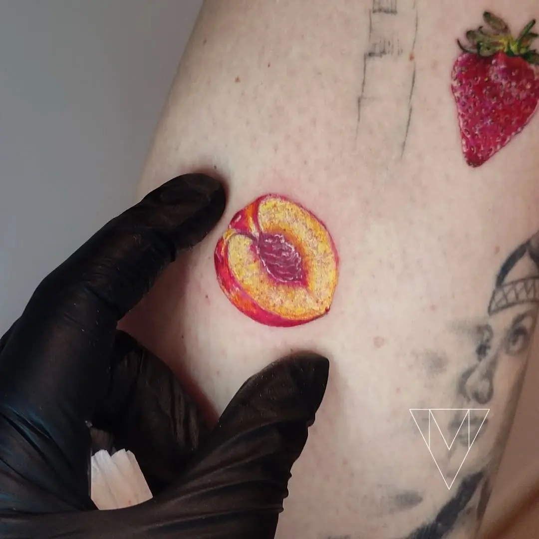 Vivid peach tattoo radiating fruity charm