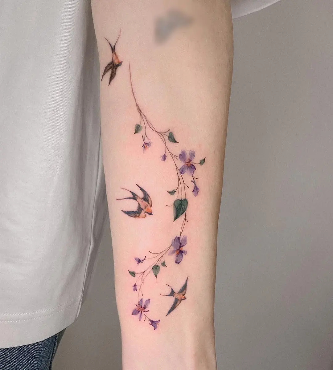 Delicate bird and vine tattoo design