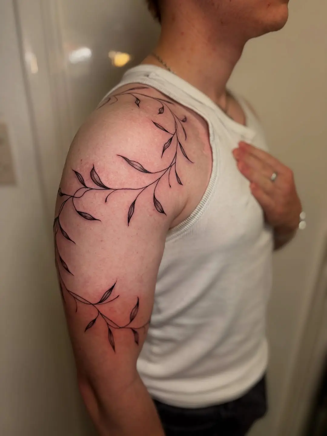 Elegant vine tattoo wrapping around the arm