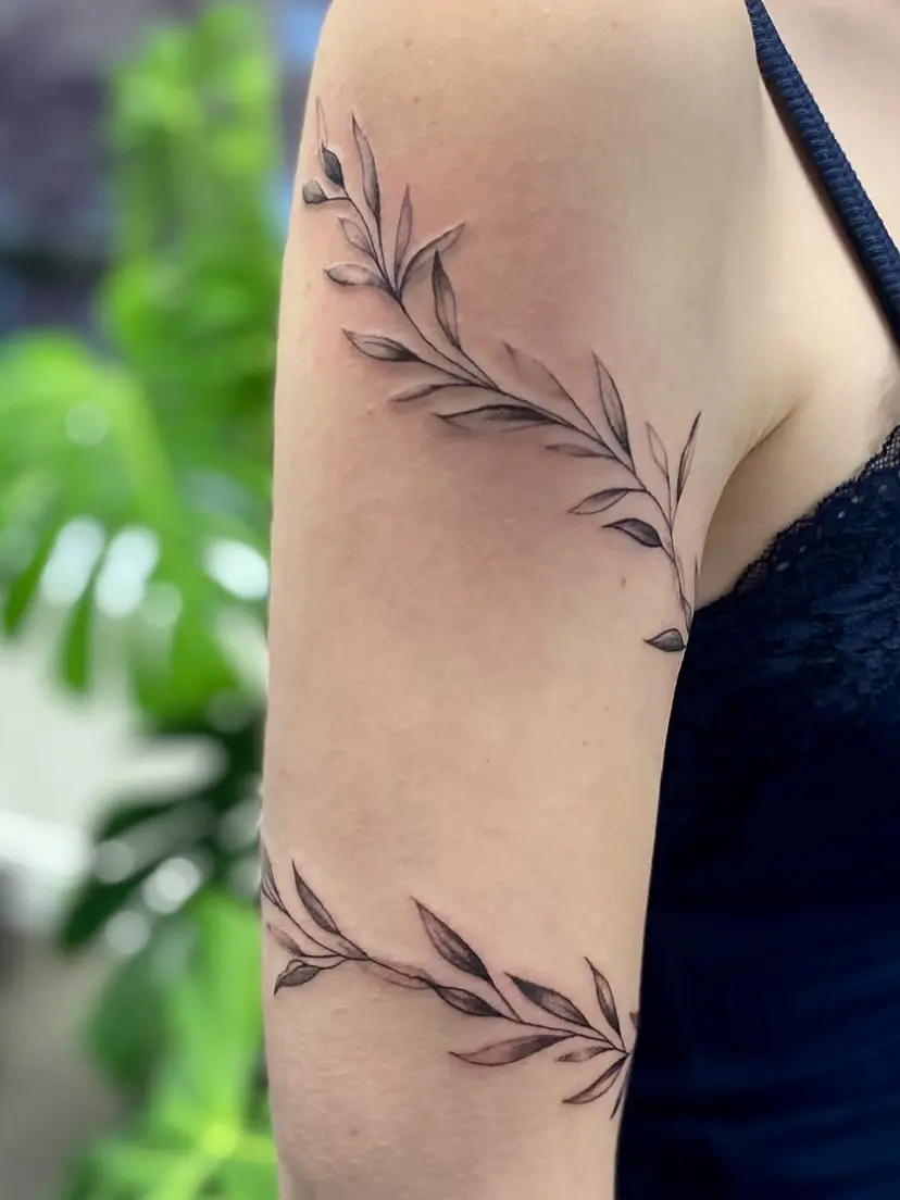 Elegant vine tattoo wrapping around arm