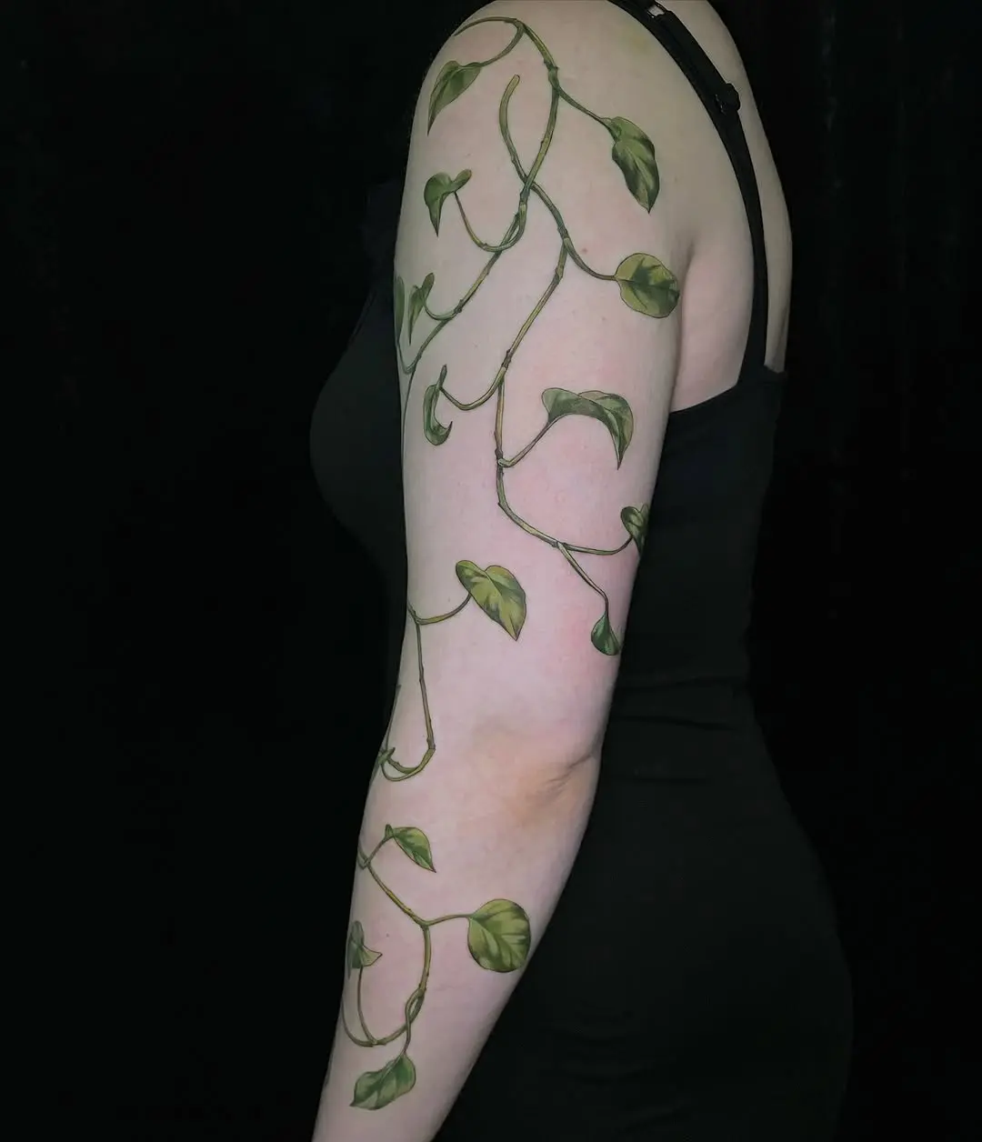 Elegant vine tattoo twining around the arm