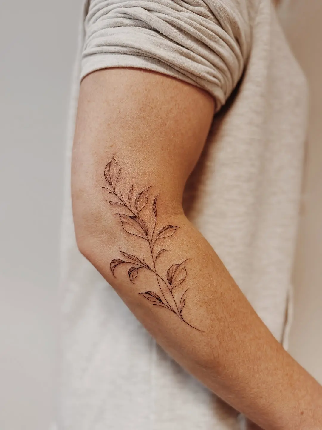 Elegant vine tattoo design on arm