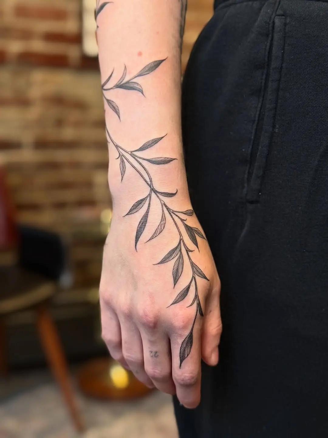 Elegant vine tattoo wrapping around the arm
