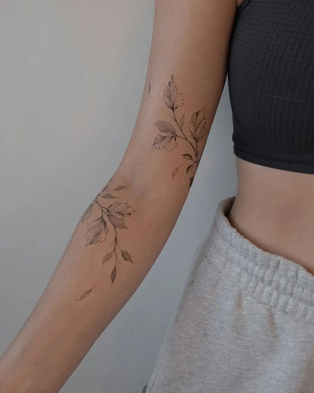 Elegant vine tattoo design on the forearm