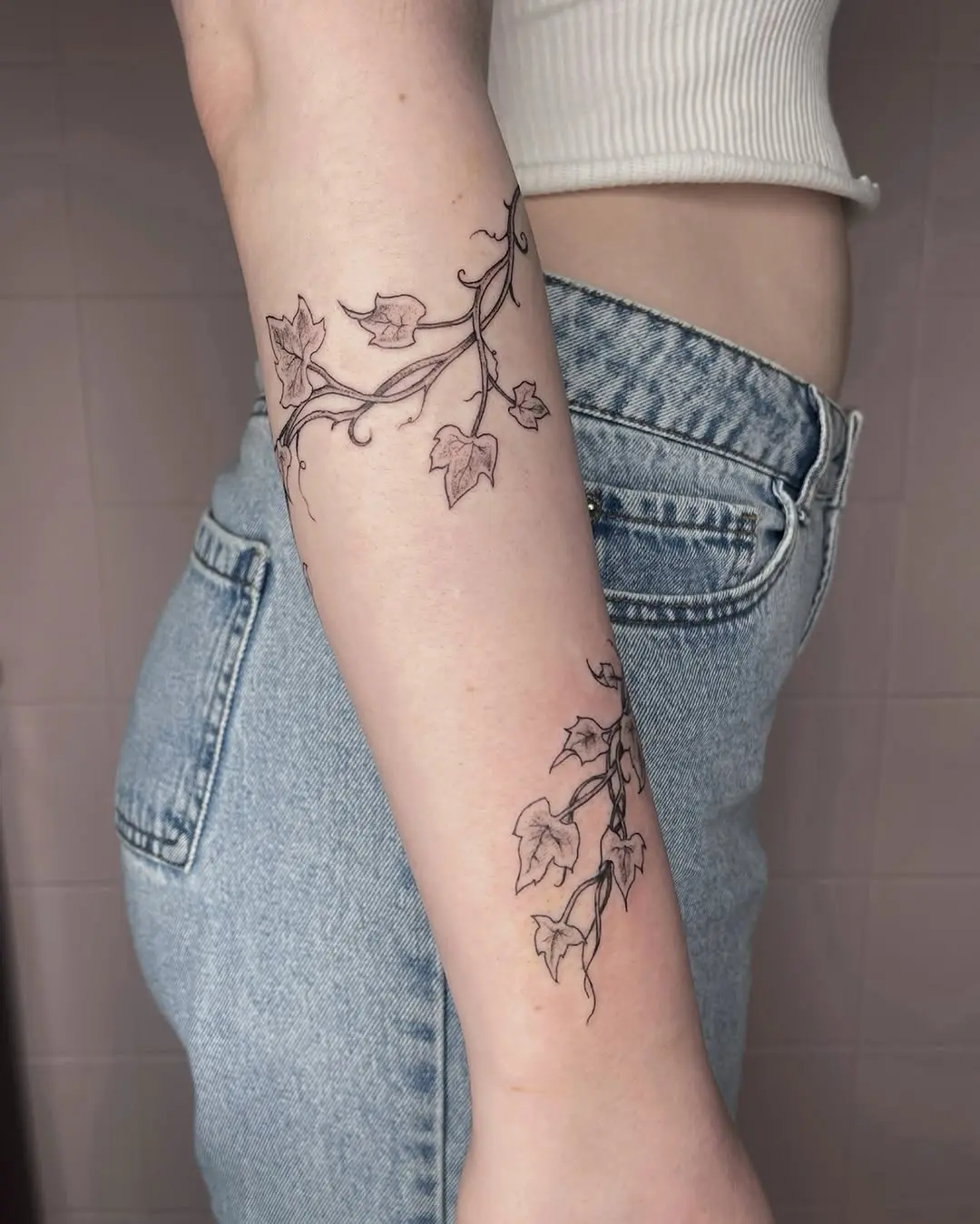 Elegant vine tattoos wrapped around the forearm