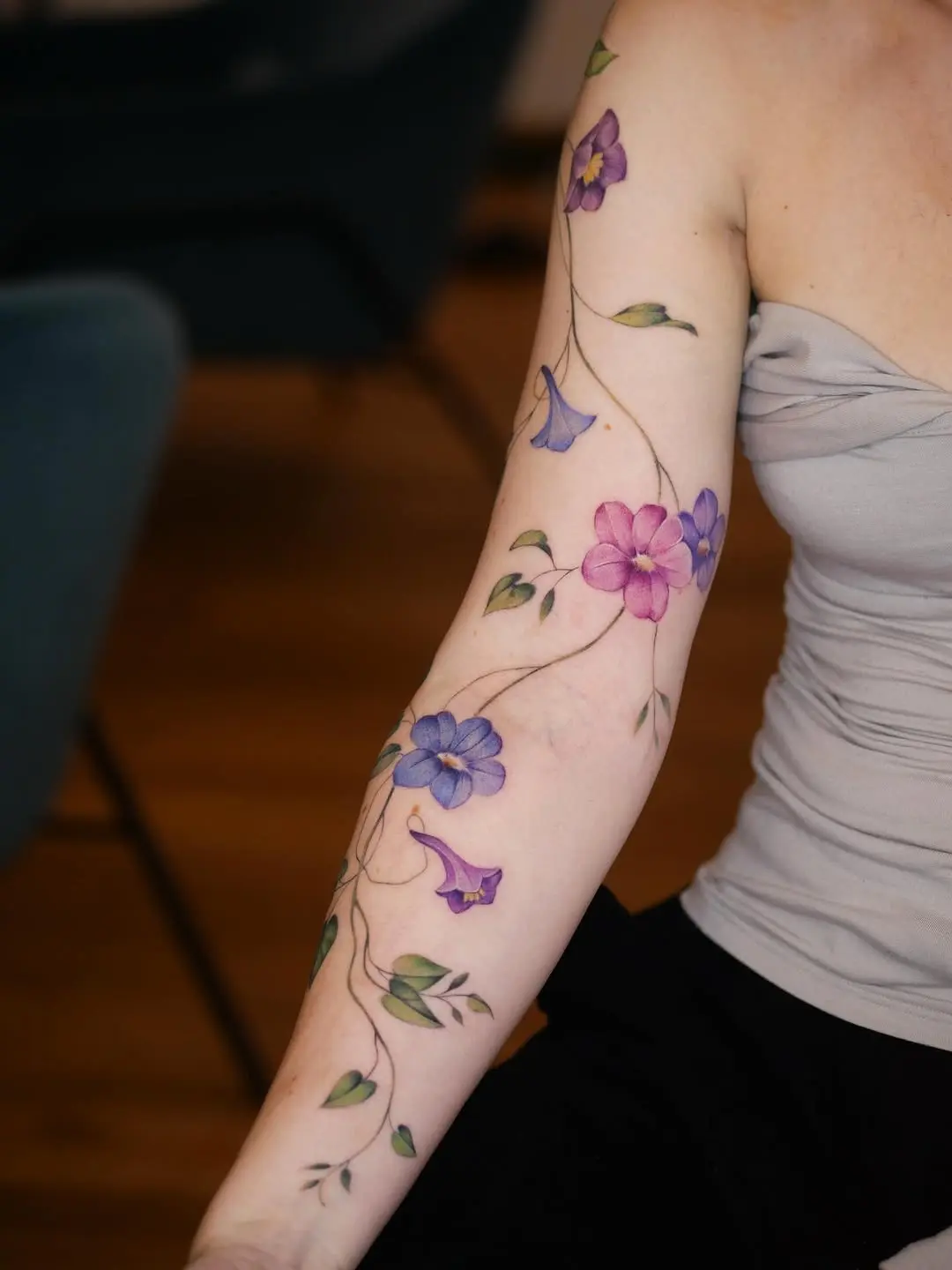 Elegant vine tattoos with colorful floral details