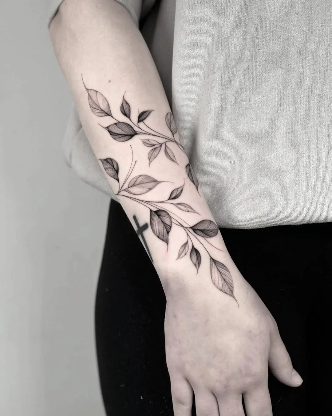 Elegant vine tattoo design on forearm