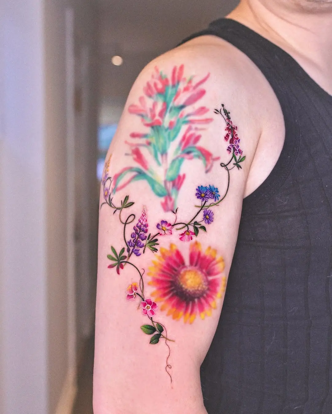 Colorful vine tattoo with floral elements