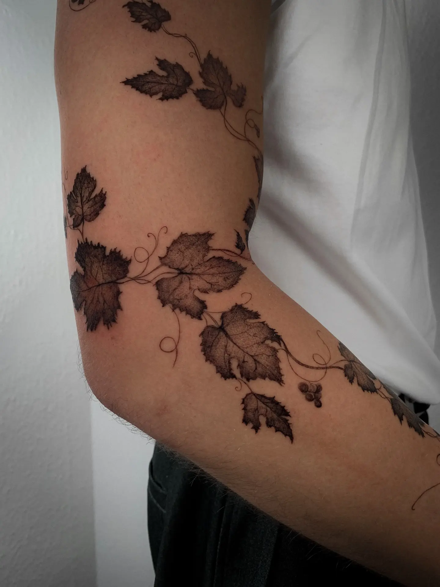 Elegant vine tattoo wrapping around the arm