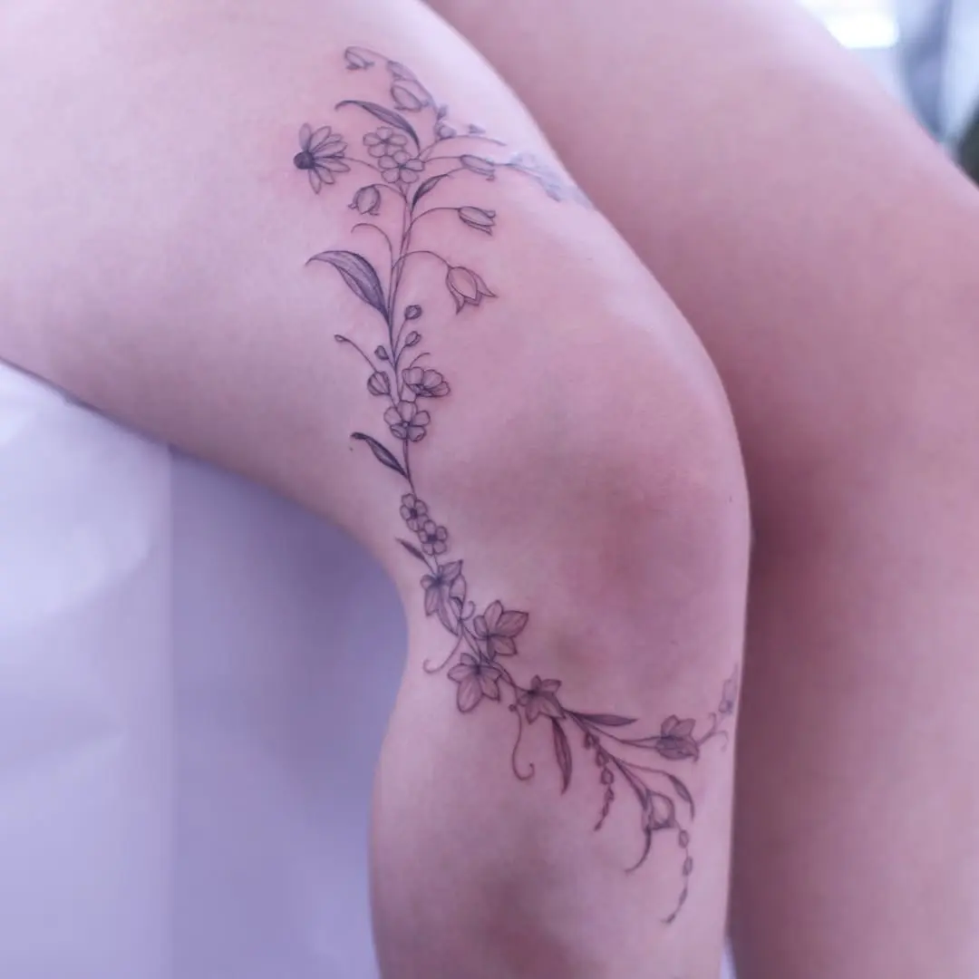 Elegant knee vine tattoo design in ink