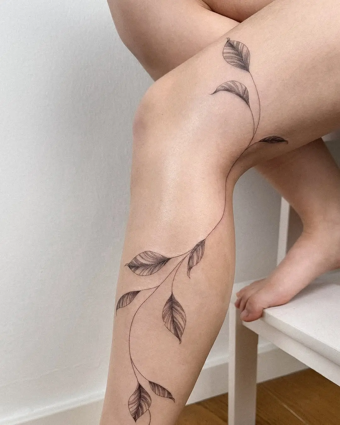 Elegant vine tattoo with delicate leaf details