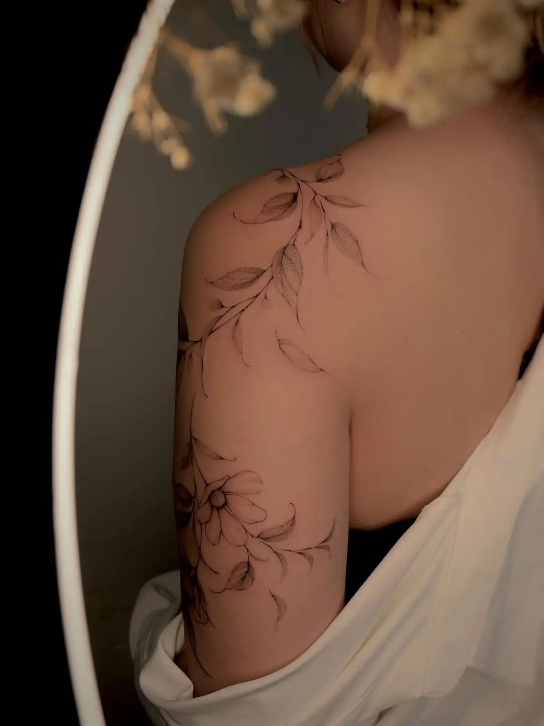 Elegant vine tattoo with delicate floral details