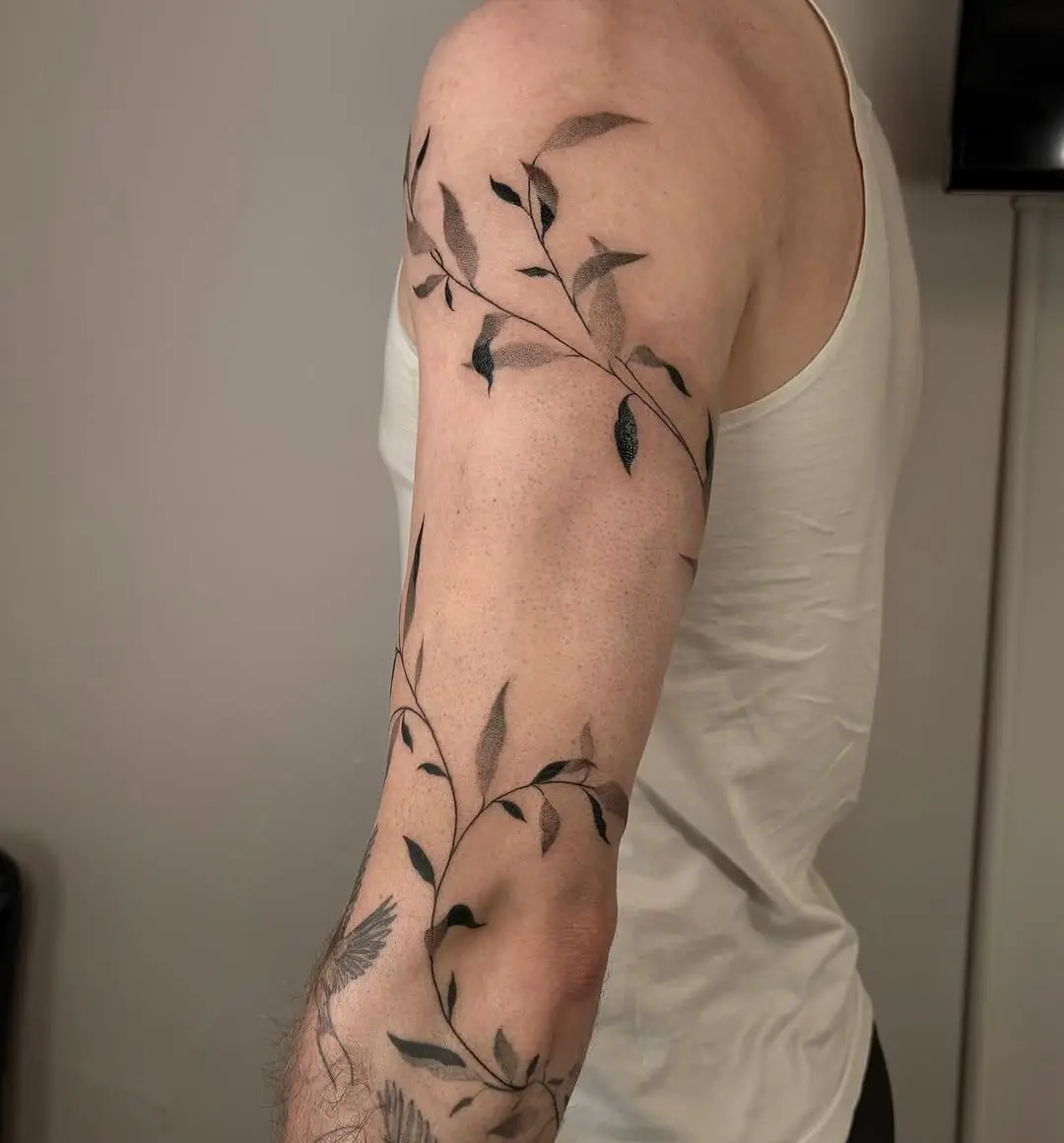 Elegant vine tattoo wrapping around the arm