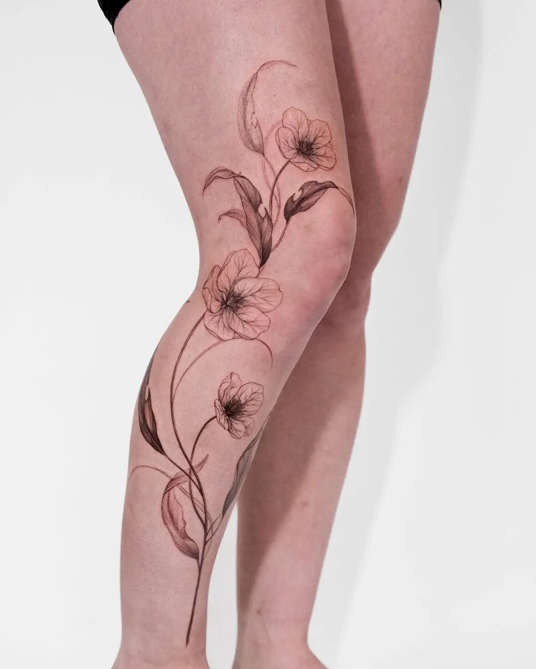 Stunning Violet Floral Tattoo on the Leg