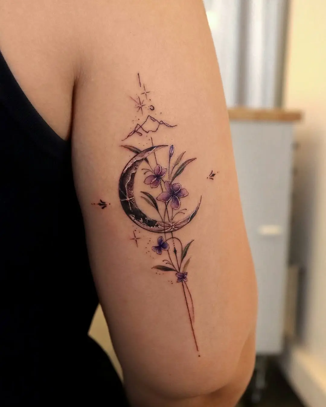 Elegant violet flowers and crescent moon tattoo
