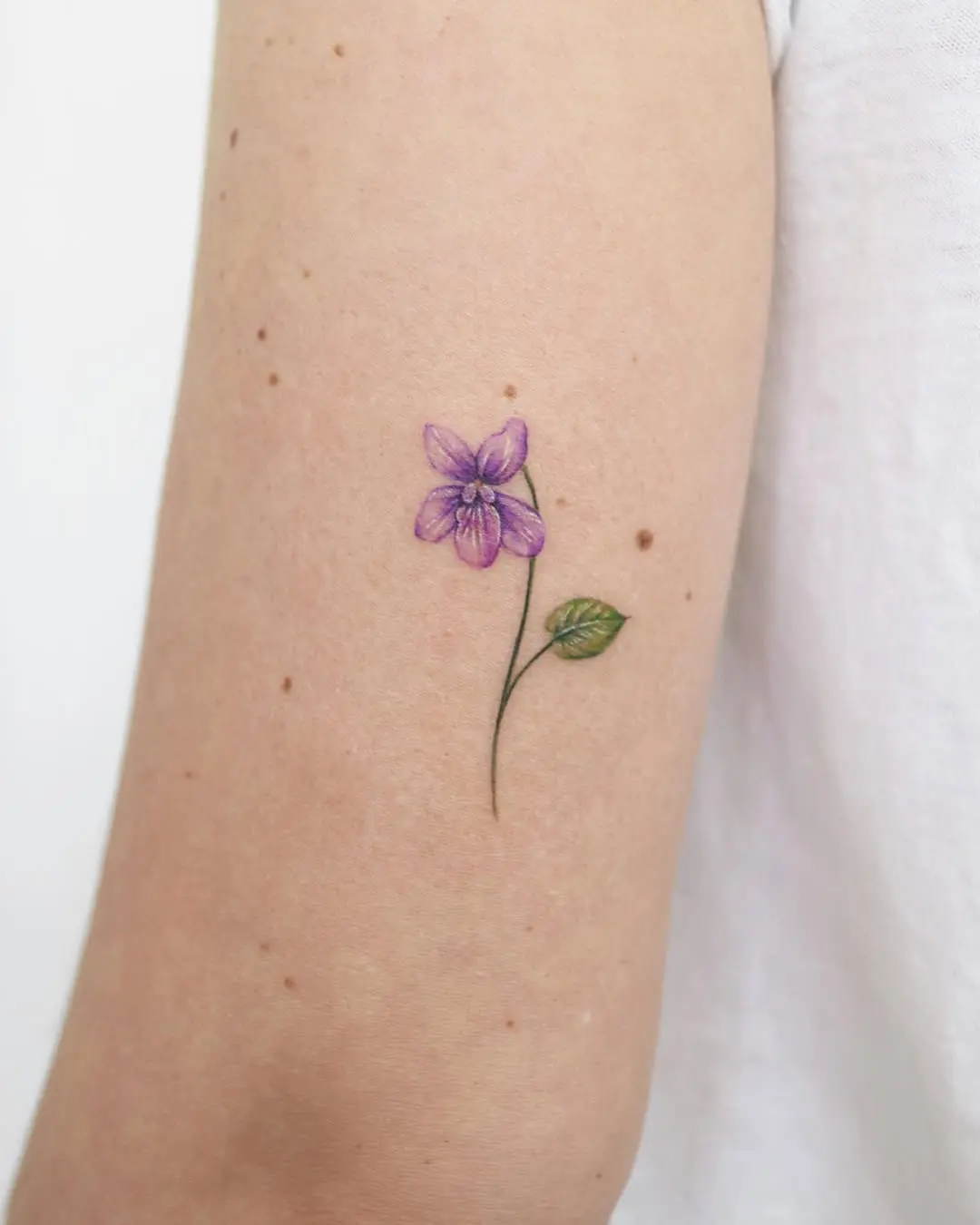 Delicate Violet Tattoo on a Bare Arm